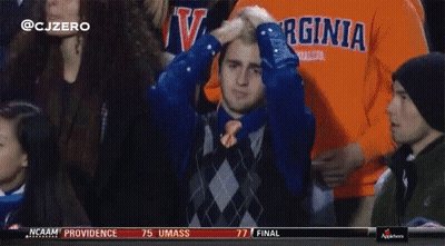 A Man In A Virginia Shirt Holds His Hand To His Head GIF