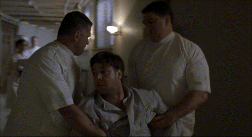 A Man In A Wheelchair Is Being Helped By A Group Of Men GIF