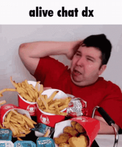 A Man In A Wheelchair Is Eating French Fries And Chicken Nuggets . GIF