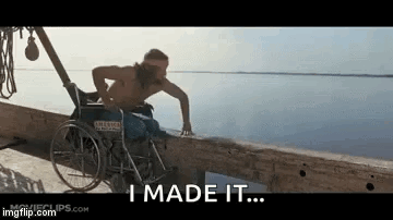 A Man In A Wheelchair Is Standing Next To A Body Of Water And Saying `` I Made It '' . GIF