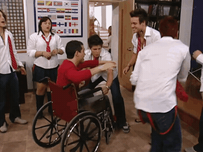 A Man In A Wheelchair Is Surrounded By People GIF