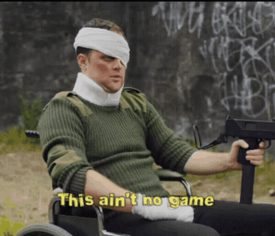 A Man In A Wheelchair With A Bandage On His Head Holds A Gun And Says This Ain T No Game GIF