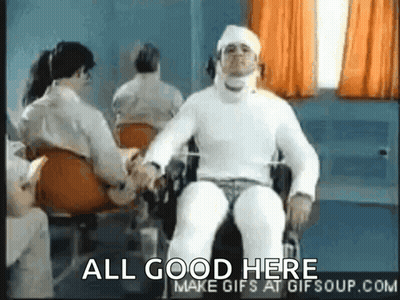 A Man In A Wheelchair With A Bandage On His Head Is Shaking Hands With Another Man . GIF