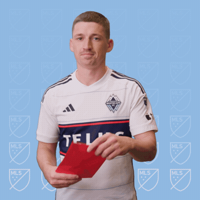 A Man In A White Adidas Shirt Holds A Red Card In His Hand GIF