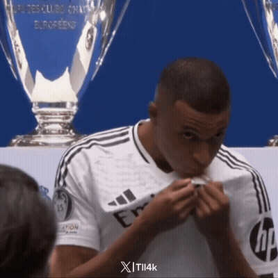 A Man In A White Adidas Shirt Is Eating Something GIF