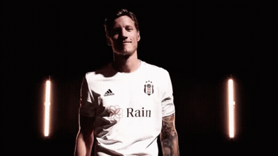 A Man In A White Adidas Shirt Is Making A Peace Sign With His Fingers . GIF