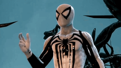 A Man In A White And Black Spiderman Costume Is Giving The Ok Sign GIF