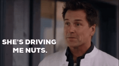 A Man In A White Coat Is Standing In Front Of A Window And Saying She 'S Driving Me Nuts . GIF