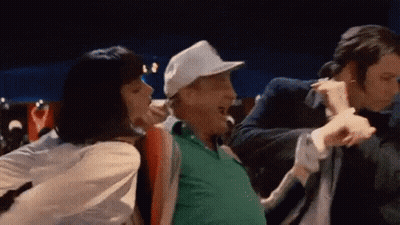 A Man In A White Hat Is Dancing With A Woman In A White Shirt . GIF