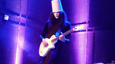A Man In A White Hat Is Playing A White Guitar GIF