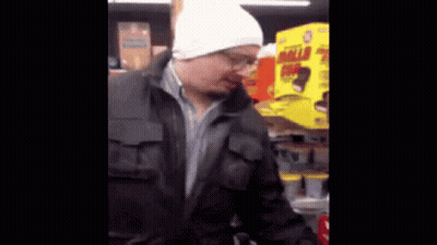 A Man In A White Hat Is Standing In Front Of A Box That Says Mild GIF