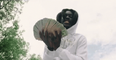 A Man In A White Hoodie Is Holding A Large Stack Of Money In His Hands . GIF
