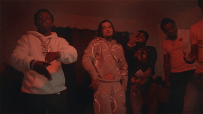 A Man In A White Hoodie With A Necklace That Says ' Snoop Dogg ' On It Is Dancing GIF