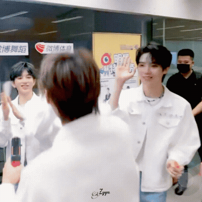 A Man In A White Jacket Is Giving A High Five GIF