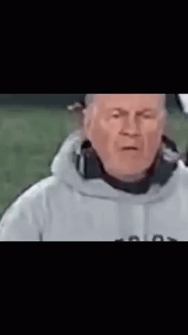 A Man In A White Jacket Is Making A Funny Face With His Eyes Closed . GIF
