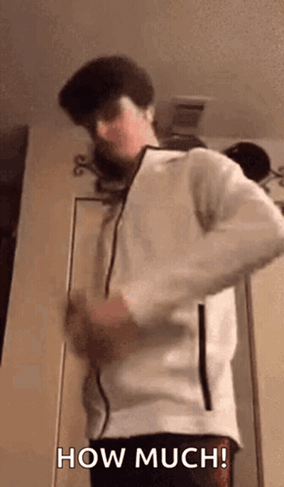 A Man In A White Jacket Is Standing In Front Of A Door And Saying How Much . GIF