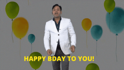 A Man In A White Jacket Says " Happy Bday To You " In Front Of Balloons GIF