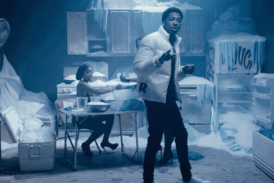 A Man In A White Jacket With The Letter R On It Stands In A Kitchen GIF
