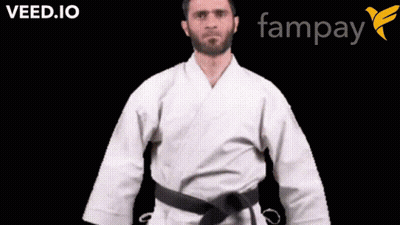 A Man In A White Karate Uniform With A Black Belt Is Standing In Front Of A Fampay Logo GIF