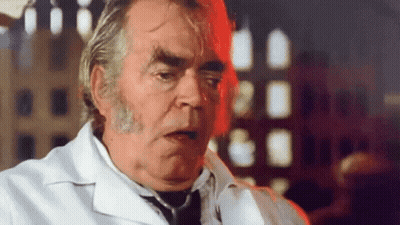 A Man In A White Lab Coat And Tie Is Talking GIF