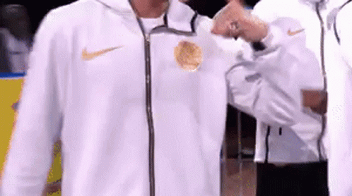 A Man In A White Nike Jacket Is Giving A Thumbs Up GIF