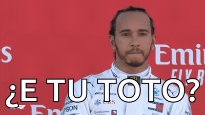 A Man In A White Racing Suit Is Standing In Front Of A Red Emirates Sign GIF