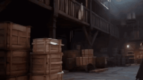 A Man In A White Robe Is Holding A Hammer And Talking To Another Man In A Black Robe GIF