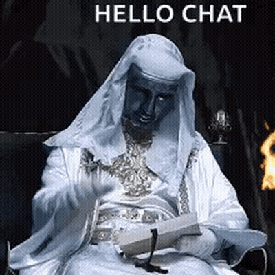 A Man In A White Robe Is Sitting In A Chair Holding A Piece Of Paper And A Candle . GIF