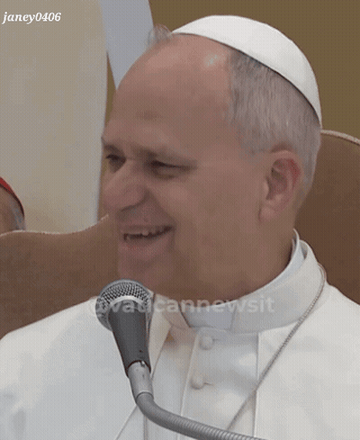A Man In A White Robe Is Smiling In Front Of A Microphone With The Watermark Janey0406 GIF