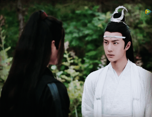 A Man In A White Robe Is Standing Next To A Man In A Black Shirt . GIF