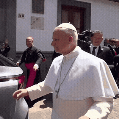 A Man In A White Robe Is Walking In Front Of A Building With A Number 30 On It GIF