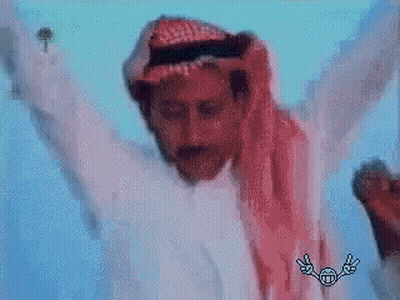A Man In A White Shirt And A Red Scarf Is Dancing With His Arms Outstretched . GIF