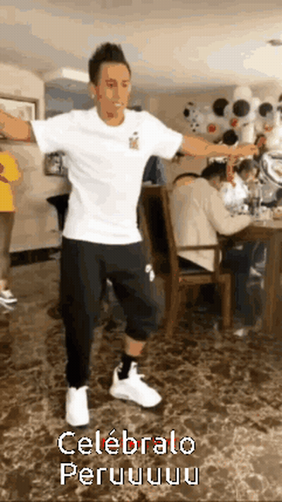 A Man In A White Shirt And Black Pants Is Dancing In A Room With The Words Celebralo Peru On The Bottom GIF
