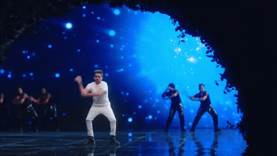A Man In A White Shirt And Black Pants Is Dancing On A Stage GIF