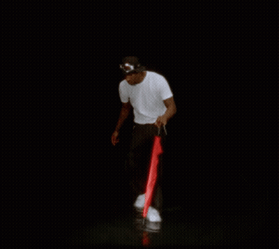 A Man In A White Shirt And Black Pants Is Holding A Red Umbrella GIF