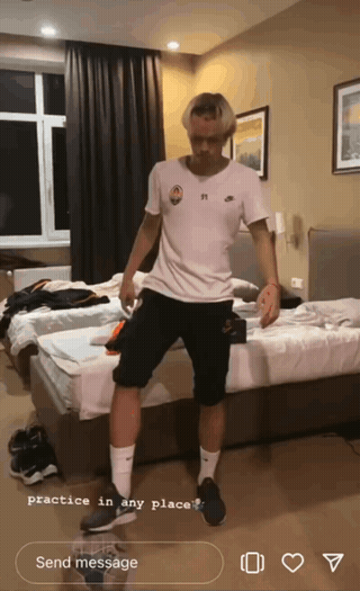 A Man In A White Shirt And Black Shorts Is Practicing In A Bedroom GIF