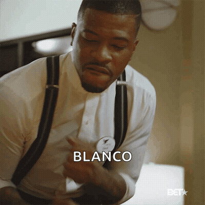 A Man In A White Shirt And Black Suspenders Has The Word Blanco On His Chest GIF