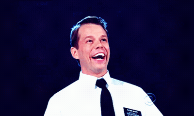 A Man In A White Shirt And Black Tie Has A Name Tag On His Chest That Says Brian Wright GIF