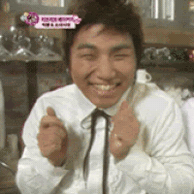 A Man In A White Shirt And Black Tie Is Smiling GIF