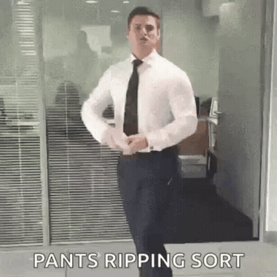 A Man In A White Shirt And Black Tie Is Standing In Front Of A Glass Door . GIF