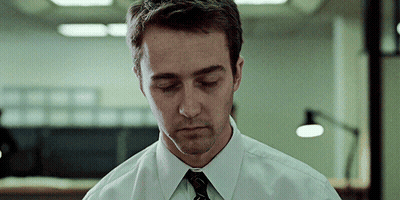 A Man In A White Shirt And Black Tie Looks Down With His Eyes Closed GIF