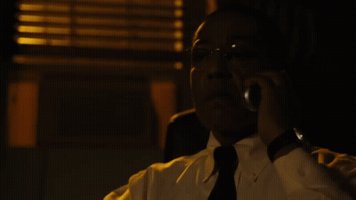 A Man In A White Shirt And Black Tie Talks On A Cell Phone GIF