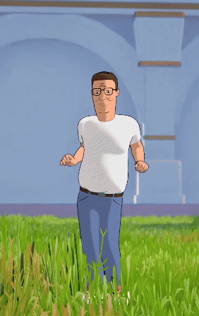 A Man In A White Shirt And Blue Jeans Stands In The Grass GIF