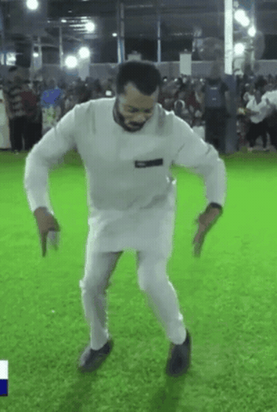 A Man In A White Shirt And Pants Is Dancing On A Field . GIF
