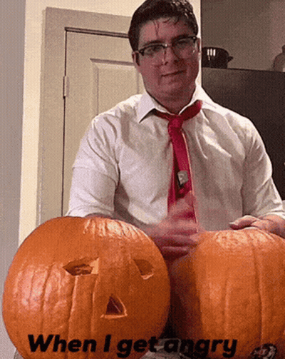 A Man In A White Shirt And Red Tie Is Holding Two Pumpkins With The Words When I Get Angry Written On Them GIF