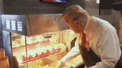 A Man In A White Shirt And Red Tie Is Looking At A Display Of Food GIF