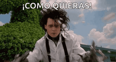 A Man In A White Shirt And Suspenders Is Holding A Pair Of Scissors In His Hand . GIF