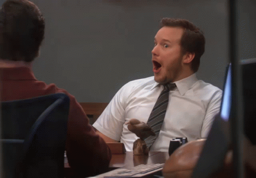 A Man In A White Shirt And Tie Has His Mouth Wide Open GIF