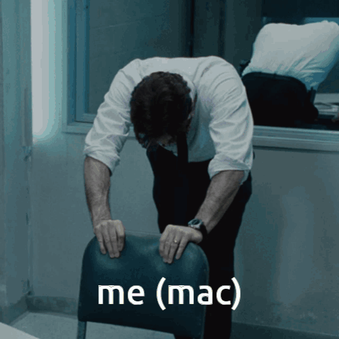 A Man In A White Shirt And Tie Is Bending Over And Holding A Chair With The Words Me ( Mac ) Written On It GIF