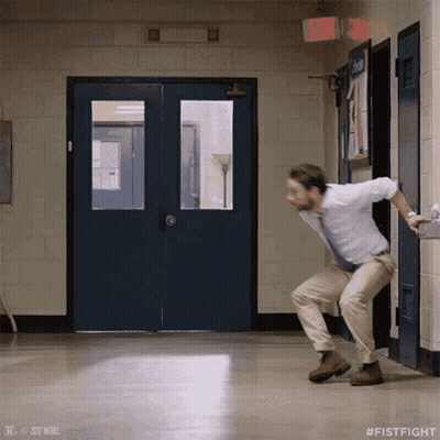 A Man In A White Shirt And Tie Is Dancing In A Hallway With # Fistfight On The Bottom GIF